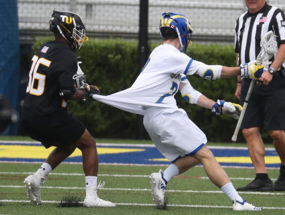 Towson's Jimmie Wilkerson (left) catches the jersey of Delaware's Jackson Finigan in a 2019 game.