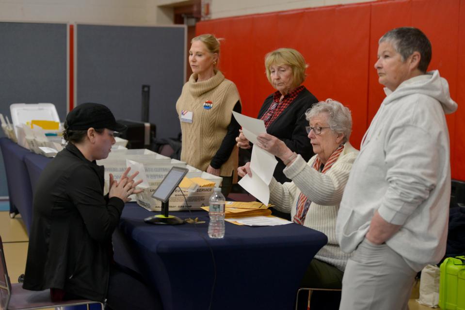 Harwich election workers Jamie Goodwin, left, and Christina Joyce process mail-in ballots as voters headed to the polls at the Harwich Community Center on Super Tuesday. To see more photos go to www.capecodtimes.com.