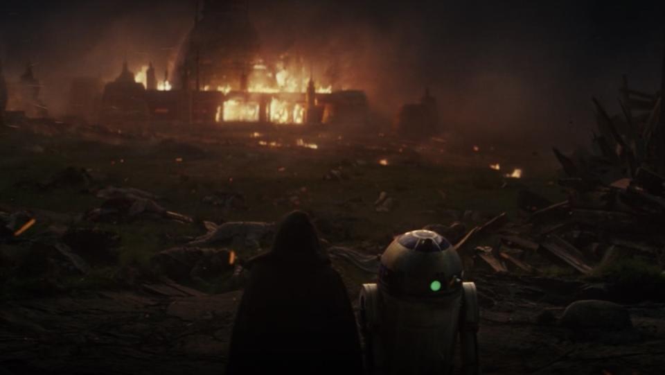 Luke Skywalker and R2-D2 watch the Jedi Temple burn in The Last Jedi