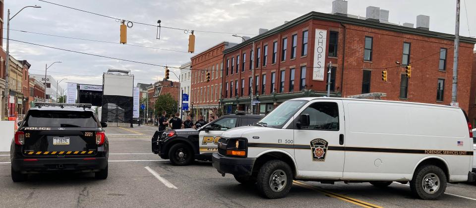 Police secure the scene at Fifth and State streets where Erie police shot a carjacking suspect shortly after 4 a.m. on Aug. 16, 2024, near the stage for the CelebrateErie festival that starts later that day.