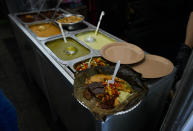 Differents types of tamales and sauces are displayed during the tamales fair in the Ixtapalapa neighborhood of Mexico City, Friday, Jan. 27, 2023. From north to south, hundreds of savory and sweet tamal varieties proliferate in Mexico. (AP Photo/Fernando Llano)