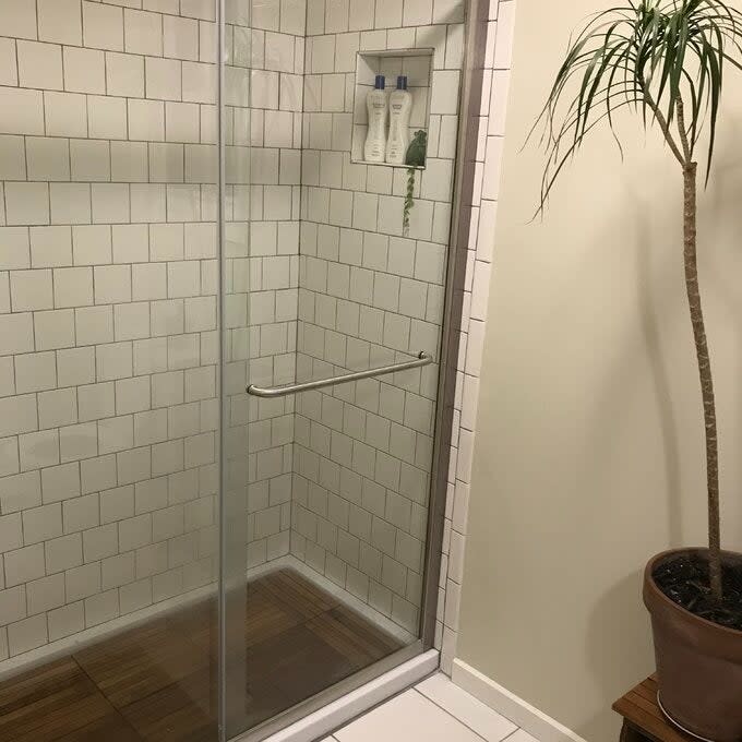 the wood floor tiles installed in a shower stall