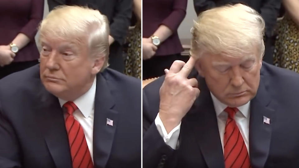 President trump staring at his staff and making what looks like an obscene gesture 