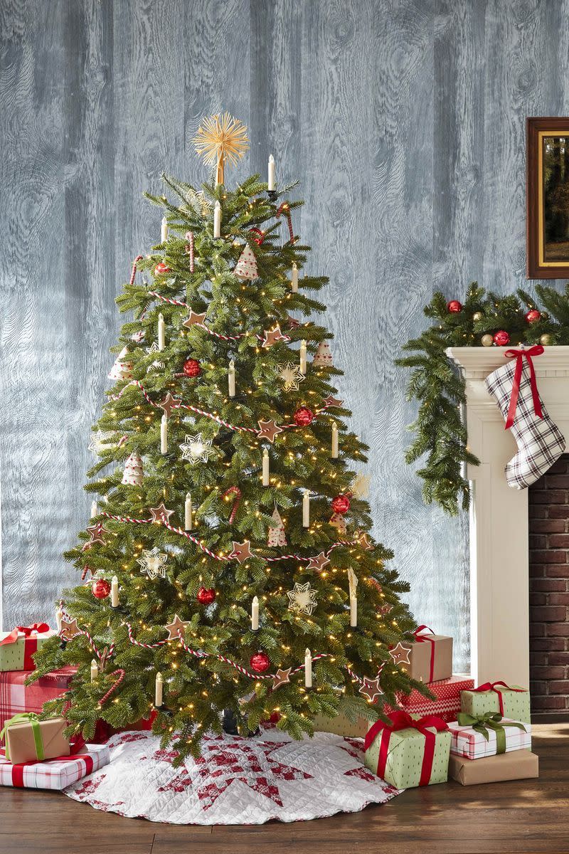 <p>This tree features details that harken back to earlier times, like a <a href="https://www.countryliving.com/diy-crafts/a33917920/gingerbread-house-cottage-instructions/" rel="nofollow noopener" target="_blank" data-ylk="slk:gingerbread;elm:context_link;itc:0;sec:content-canvas" class="link ">gingerbread</a> garland, electric candles (a nod to the early way trees were illuminated), and a straw star on top. A quilted <a href="https://www.countryliving.com/uk/homes-interiors/interiors/g175/christmas-tree-skirts/" rel="nofollow noopener" target="_blank" data-ylk="slk:tree skirt;elm:context_link;itc:0;sec:content-canvas" class="link ">tree skirt</a> rounds out the homespun vibe.</p><p><a class="link " href="https://www.amazon.com/Flameless-Christmas-Candle-Indoor-String/dp/B01GVSZV9E/ref=sr_1_5?crid=2FDHA6E7B7I0K&dchild=1&keywords=clip+on+candles+for+christmas+tree&qid=1603203705&sprefix=clip+on+candles%2Caps%2C333&sr=8-5&tag=syn-yahoo-20&ascsubtag=%5Bartid%7C10050.g.1251%5Bsrc%7Cyahoo-us" rel="nofollow noopener" target="_blank" data-ylk="slk:SHOP FLAMELESS CANDLES;elm:context_link;itc:0;sec:content-canvas">SHOP FLAMELESS CANDLES</a></p>