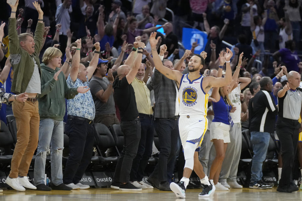 Golden State Warriors guard Stephen Curry celebrates in front of fans after the Warriors defeated the Sacramento Kings in an NBA preseason basketball game in San Francisco, Wednesday, Oct. 18, 2023. (AP Photo/Jeff Chiu)