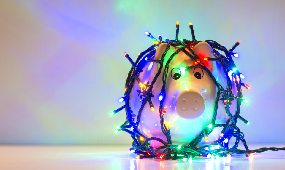 Piggy bank wrapped in Christmas string lights