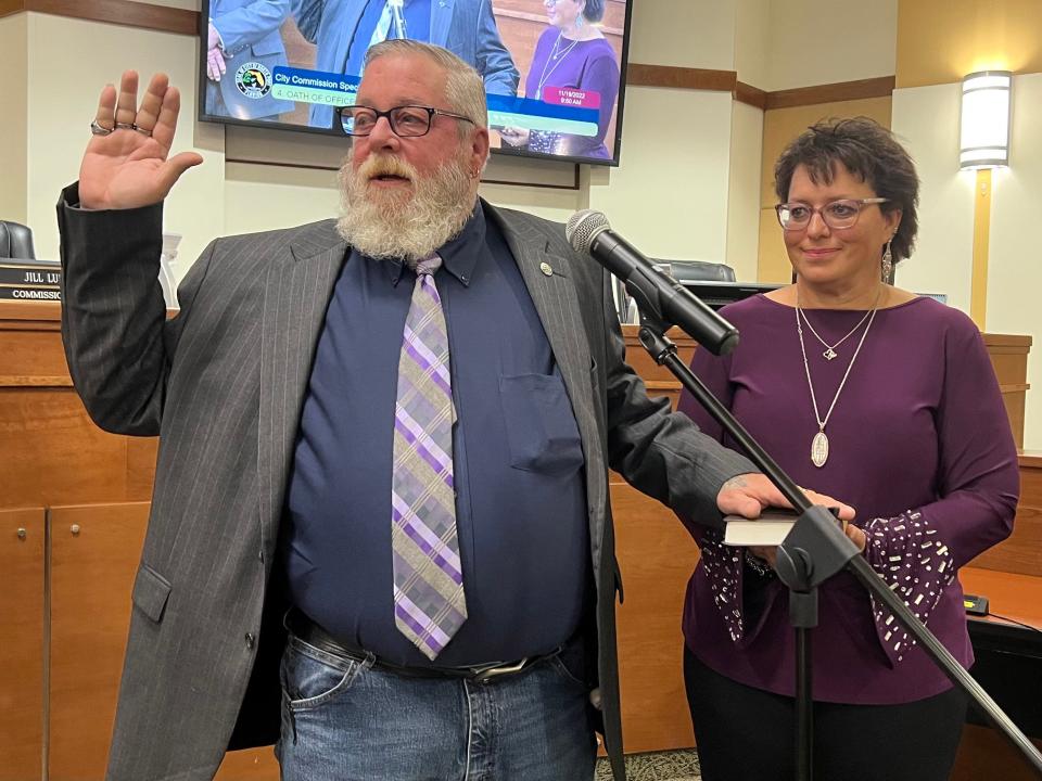 Pete Emrich takes the oath of office to serve his second term as the District 4 representative on the North Port City Commission, with Elaine Emrich holding the Bible, at a Saturday morning special meeting.