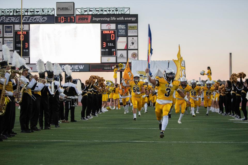 The Pueblo East High School football team take the field at Dutch Clark Stadium at the start of the 46th annual Cannon Game on Friday, Sept. 23, 2022.
