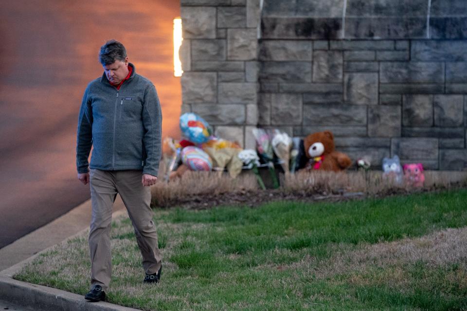 Curtis McDowell, who lives near the school, walks away after placing flowers outside of Covenant School in Nashville on Monday.