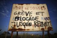 A message reads "Strike and blockade until withdrawal" near a barricade to block the entrance of the depot of the SFDM company near the oil refinery to protest the government's proposed labor law reforms in Donges, France, May 26, 2016. REUTERS/Stephane Mahe