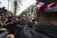 <p>An anti-Trump protester, left, and a Trump supporter clash outside a campaign rally by presumptive GOP presidential candidate Donald Trump at the Anaheim Convention Center on May 25, 2016, in Anaheim, Calif. (David McNew/Getty Images) </p>