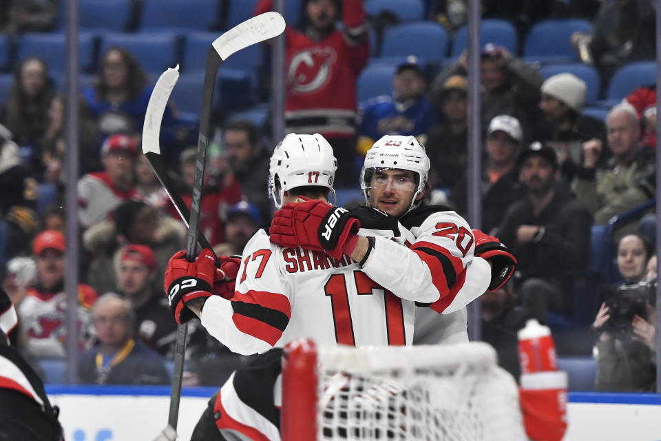 New Jersey Devils center Michael McLeod, right, celebrates with center Yegor Sharangovich after scoring against the Buffalo Sabres during the first period of an NHL hockey game in Buffalo, N.Y., Friday, March 24, 2023. (AP Photo/Adrian Kraus)