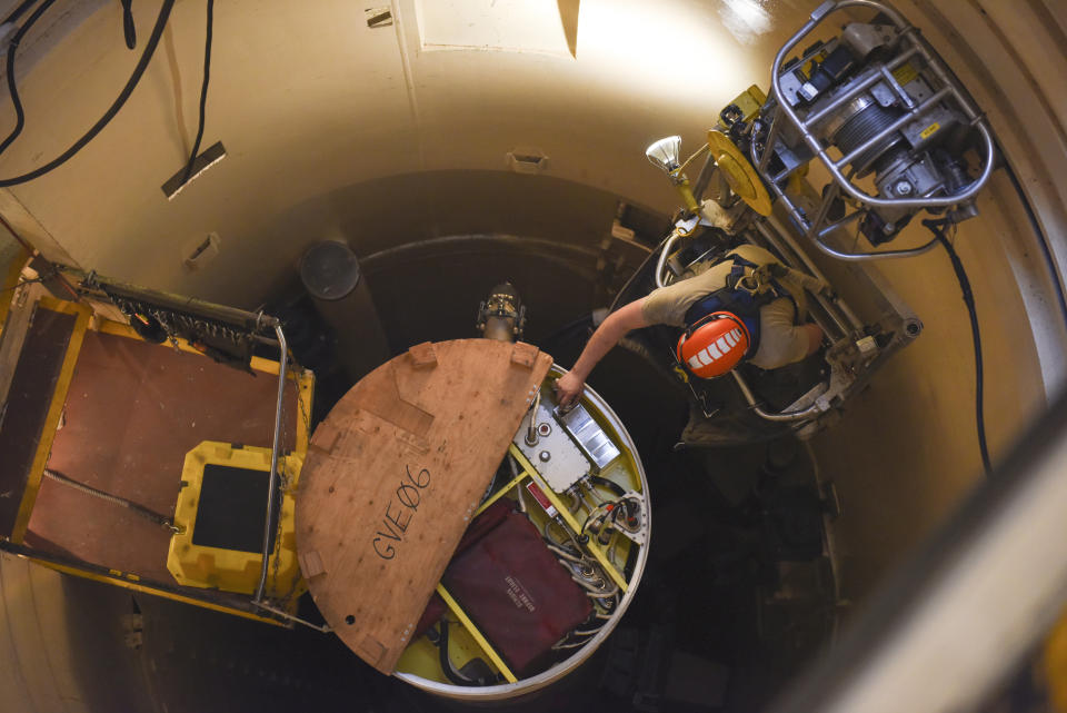 In this image provided by the U.S. Air Force, Airman 1st Class Jackson Ligon, 341st Missile Maintenance Squadron technician, examines the internals of an intercontinental ballistic missile during a Simulated Electronic Launch-Minuteman test Sept. 22, 2020, at a launch facility near Malmstrom Air Force Base in Great Falls, Mont. The top Air Force officer in charge of the nation's air and ground-launched nuclear missiles has requested an official investigation into the number of officers who are reporting the same type of blood cancer after serving at Malmstrom Air Force Base. (Tristan Day/U.S. Air Force via AP)