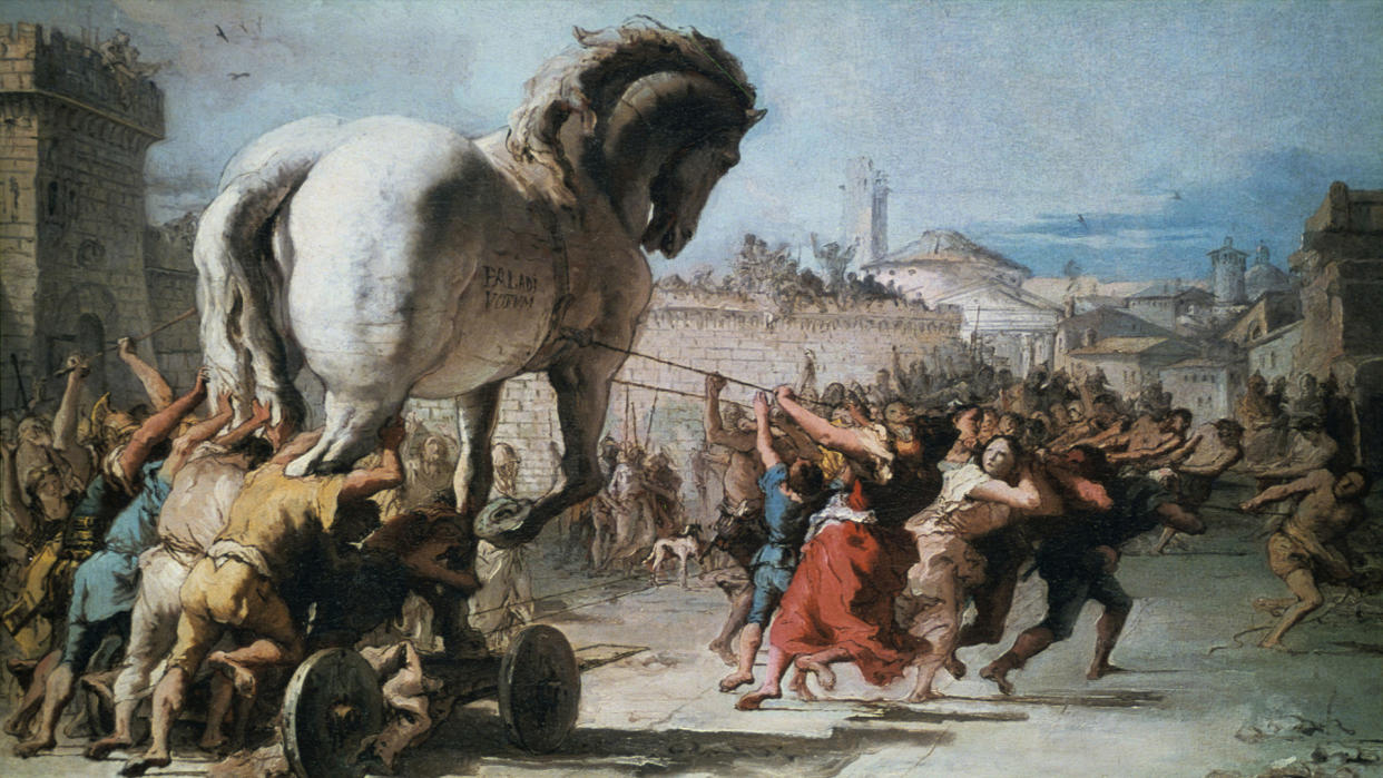  An illustration of the people of Troy bringing in the Trojan horse, which was filled with their Greek enemies, as told in Homer's "The Iliad.". 