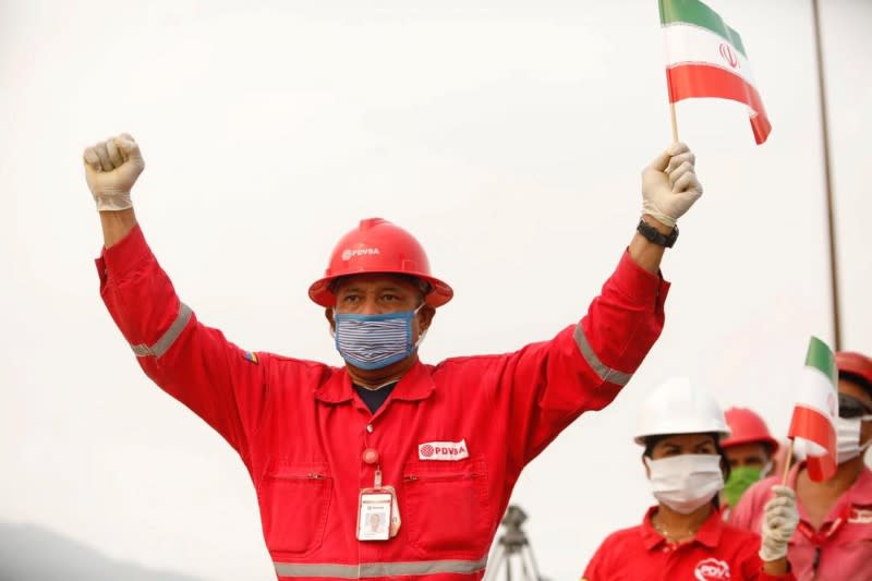 FOTO DE ARCHIVO- Un trabajador de la estatal petrolera PDVSA sostiene una bandera de Irán durante la llegada del buque petrolero iraní "Fortune" a la refinería El Palito en Puerto Cabello