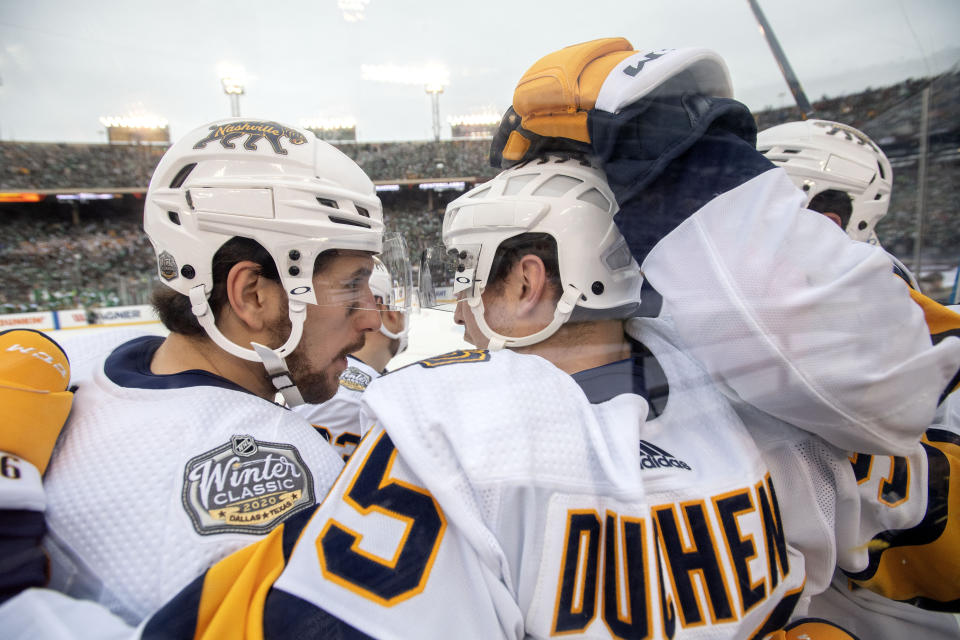 Nashville Predators left wing Filip Forsberg, left, congratulates center Matt Duchene (95) after Duchene's goal against the Dallas Stars in the first period of the NHL Winter Classic hockey game between the Dallas Stars and the Nashville Predators at the Cotton Bowl, Wednesday, Jan. 1, 2020, in Dallas. (AP Photo/Jeffrey McWhorter)