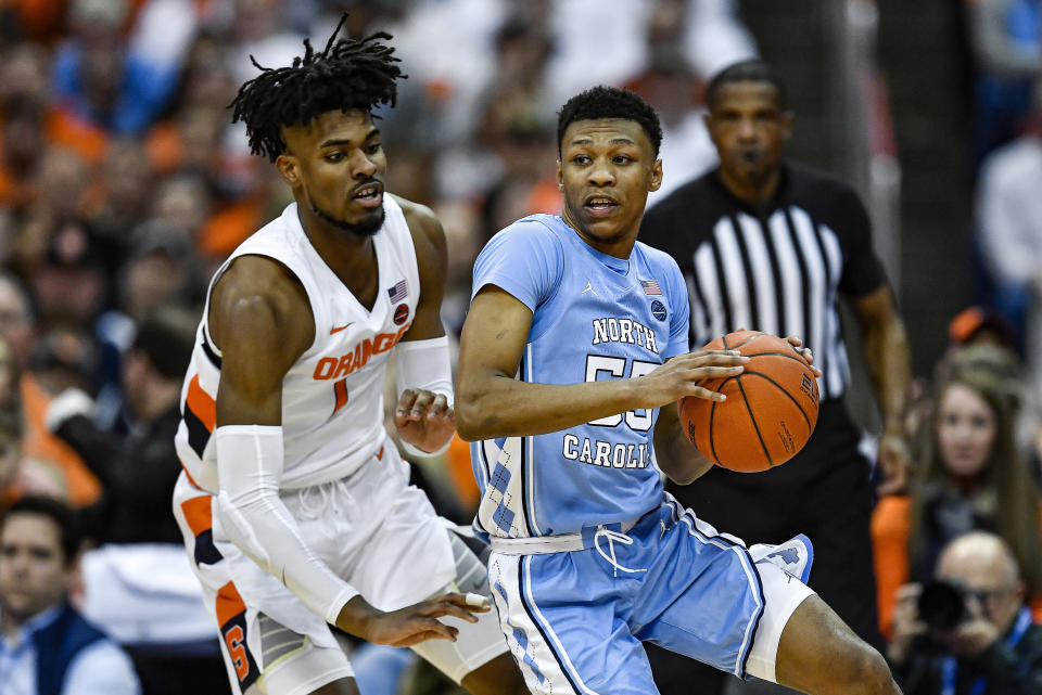 North Carolina guard Christian Keeling, right, is defended by Syracuse forward Quincy Guerrier during the second half of an NCAA college basketball game in Syracuse, N.Y., Saturday, Feb. 29, 2020. North Carolina defeated Syracuse 92-79. (AP Photo/Adrian Kraus)