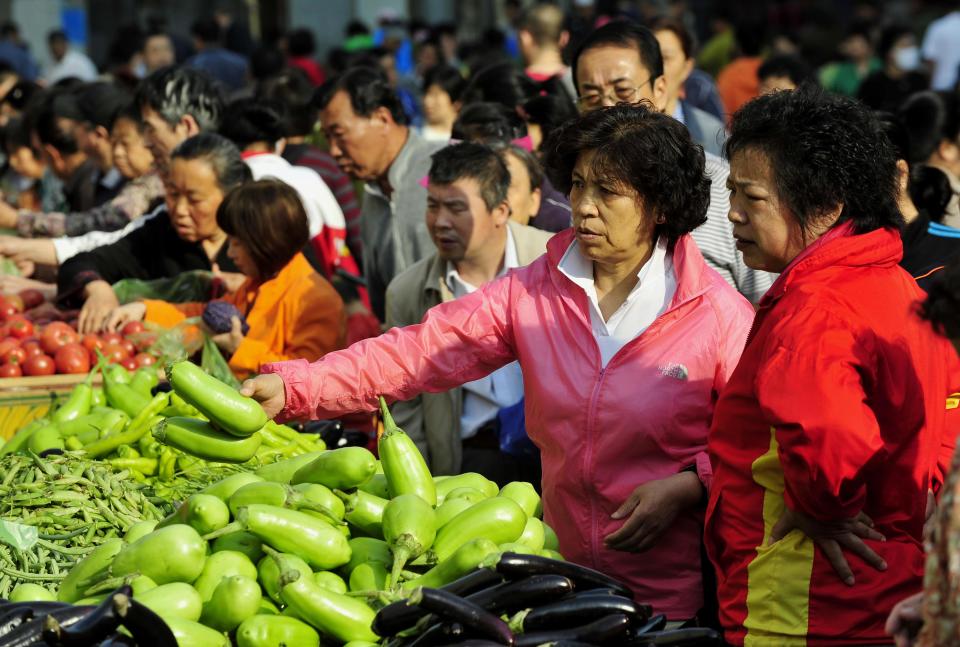 A woman buys fresh vegetables at a market in Shenyang in northeast China's Liaoning province, Thursday May 10, 2012. China's inflation rate slowed slightly to 3.4 percent in April, down from 3.6 percent a month earlier, giving the government greater leeway to ease policy to boost the economy. (AP Photo) CHINA OUT