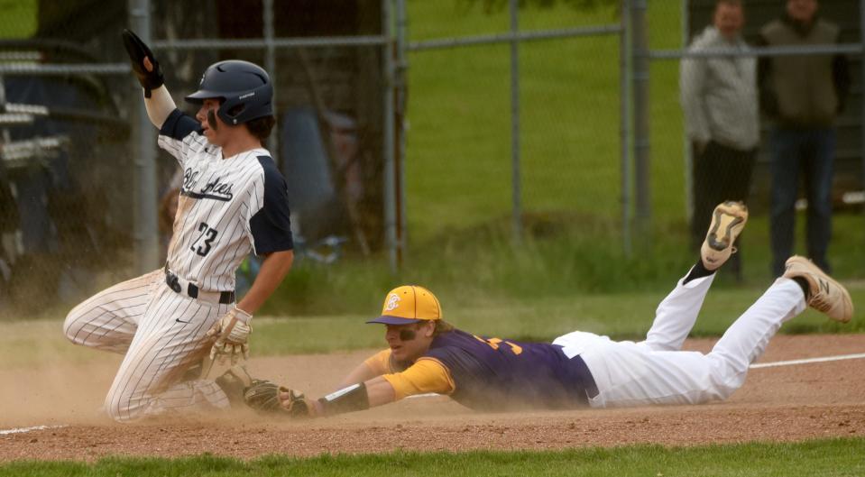 Granville's Nolan Tracy makes it past the tag from Bloom-Carroll third baseman Joel Winters after tagging up on a fly ball Monday during their Division II district semifinal. The Blue Aces blanked the Bulldogs 1-0.