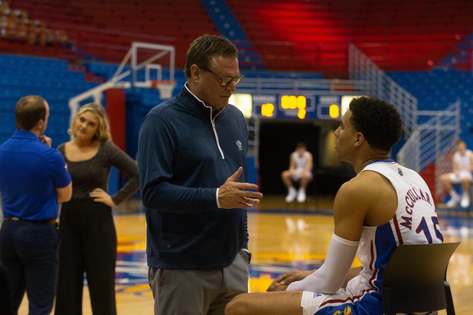 Kansas head coach Bill Self takes a moment to speak with redshirt senior guard Kevin McCullar Jr. (15) during media day interviews Tuesday inside Allen Fieldhouse.