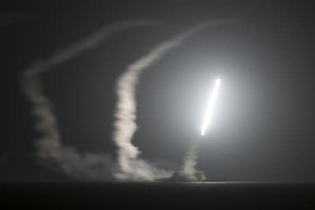 The guided-missile cruiser USS Philippine Sea (CG 58) launches a Tomahawk cruise missile, as seen from the aircraft carrier USS George H.W. Bush (CVN 77), in the Arabian Gulf in this handout photograph taken and provided on September 23, 2014. REUTERS/Mass Communication Specialist 1st Class Eric Garst/U.S. Navy/Handout