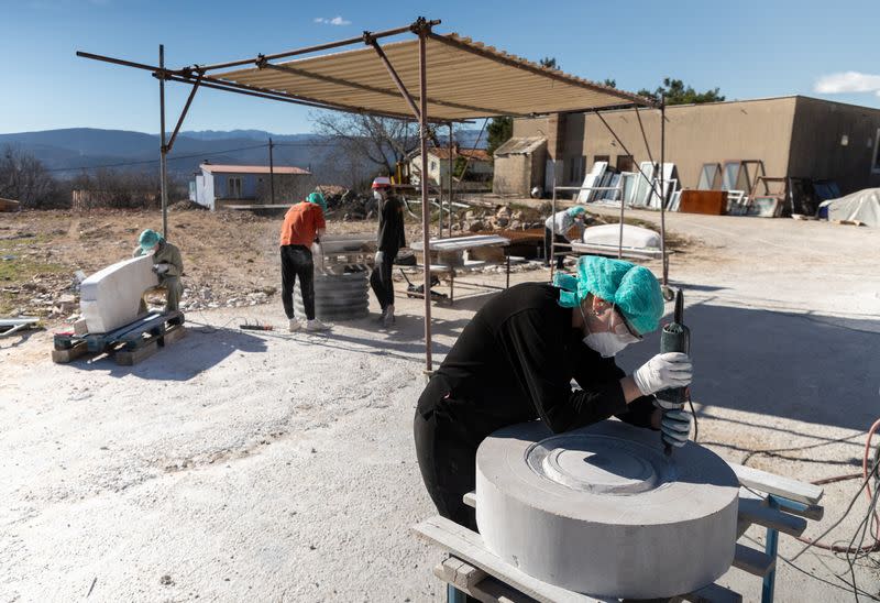 Artists work on a life size Mercedes monument in Imotski