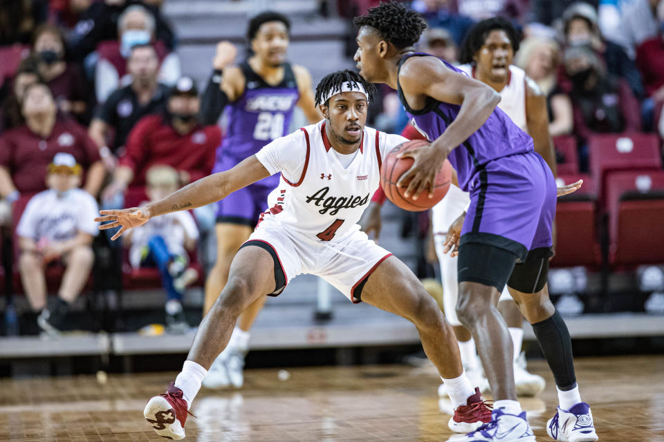 Mario McKinney Jr. (4) defends as the New Mexico State Aggies face off against the Abilene Christian Wildcats at the Pas American in Las Cruces on Saturday, Jan. 15, 2022.