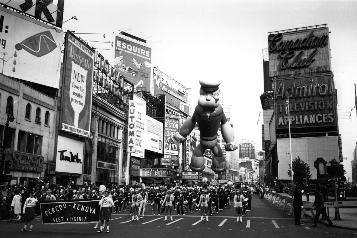 A Thanksgiving parade in New York. Floating above the majorettes is a giant inflatable Popeye.