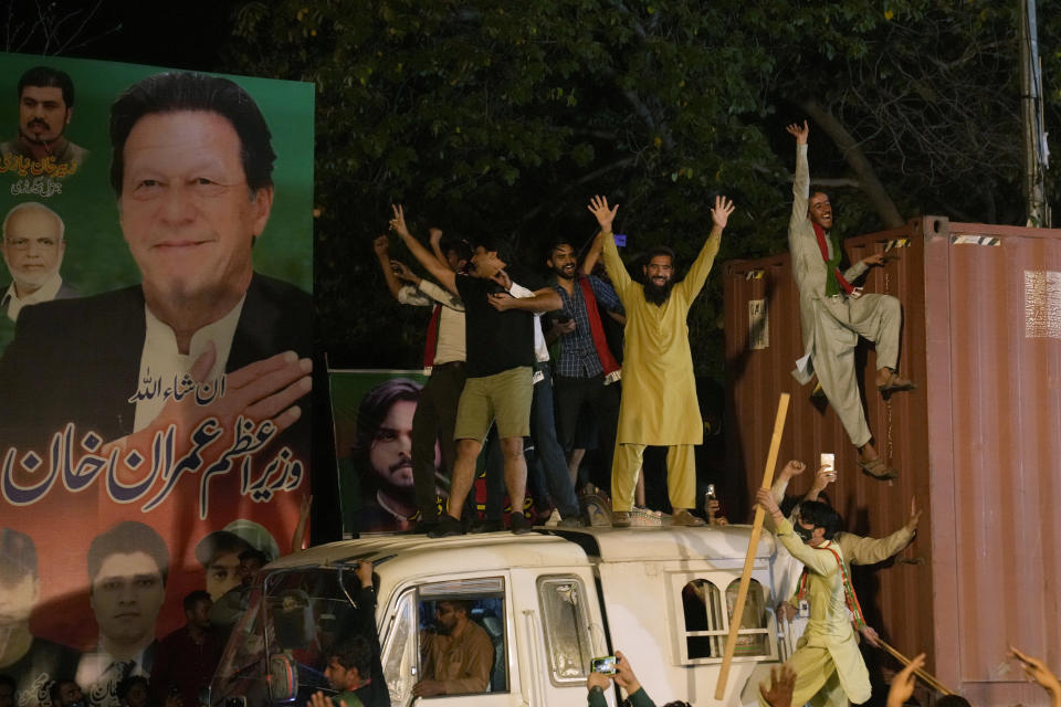 Supporters of former Prime Minister Imran Khan greet their leader upon is arrival at his home in Lahore, Pakistan, early Saturday, May 13, 2023. A high court in Islamabad on Friday granted former Prime Minister Imran Khan protection from arrest in a graft case and ordered him freed on bail. (AP Photo/K.M. Chaudary)