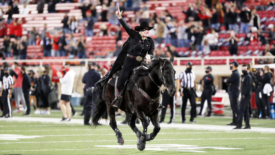 Texas Tech's Masked Rider Cameron Hekkert rides before an NCAA college football game against Oklahoma, Saturday, Oct. 31, 2020, in Lubbock, Texas. (AP Photo/Mark Rogers)