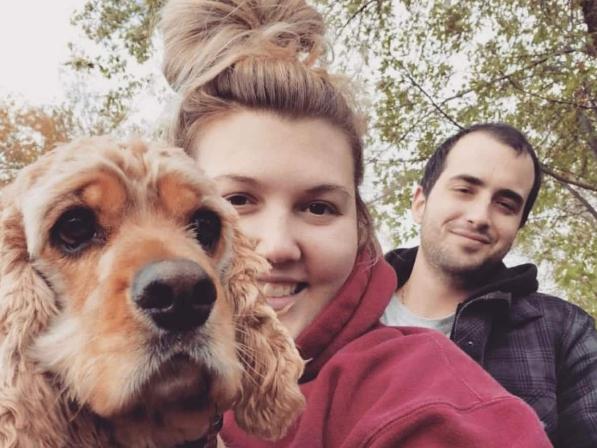 Carissa MacDonald and Aaron Stone are pictured with their dog, Max. (Submitted by Victoria Green - image credit)