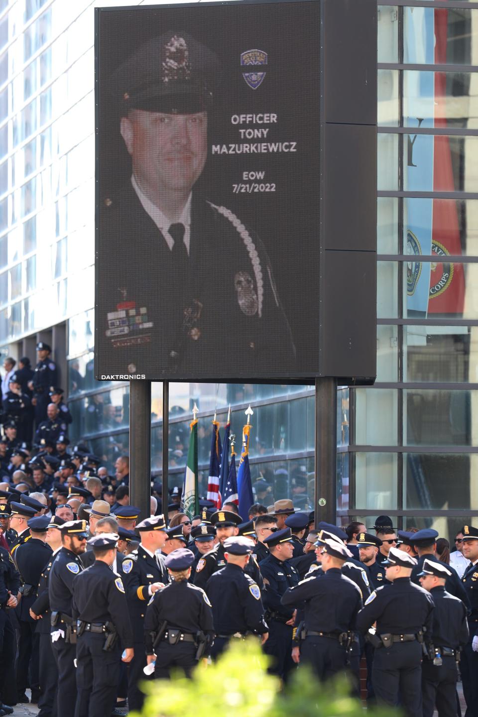 An  sign outside of the Blue Cross Arena shows Rochester officer Anthony Mazurkiewicz in uniform with the date he was killed.