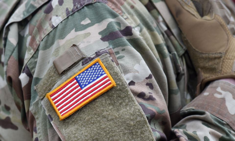 A US flag is pictured on a soldier's uniform during an artillery live fire event by the US Army Europe's 41st Field Artillery Brigade at the military training area in Grafenwoehr, southern Germany, on March 4, 2020. - The 41st Field Artillery Brigade plans, prepares, executes and assesses operations to provide US Army Europe with long-range precision strike capabilities.