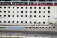 Fans on the patios of condos watch as race leader Josef Newgarden comes out of Turn 2 during an IndyCar auto race at Texas Motor Speedway in Fort Worth, Texas, Saturday, June 6, 2020. Condo residents were the only fans able to watch the race live. (AP Photo/Tony Gutierrez)