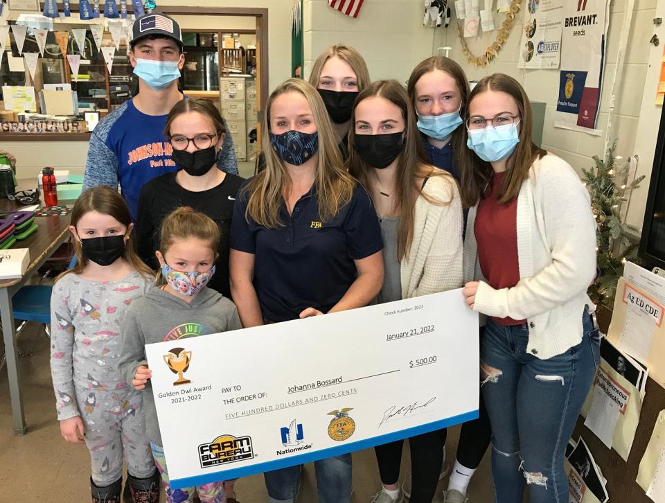 Hamilton Central School agriculture teacher Johanna Bossard, center, is surrounded by students and her daughters Brynley and Raegan Jan. 21 after receiving the Golden Owl Award as a finalist for state ag teacher of the year.