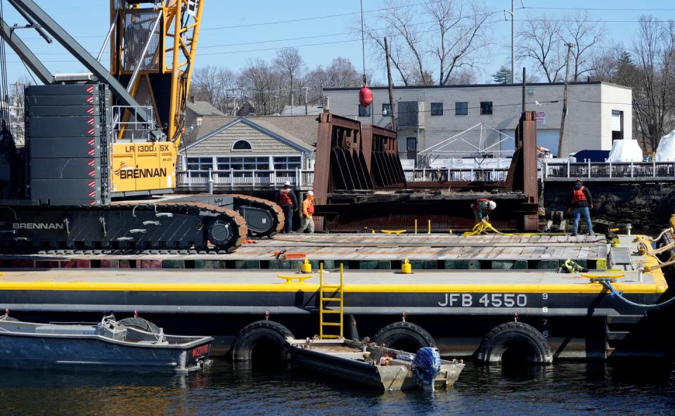 Workers with J.F. Brennan Co. on Thursday began removing what's left of the India Point Railroad Bridge from the Seekonk River.