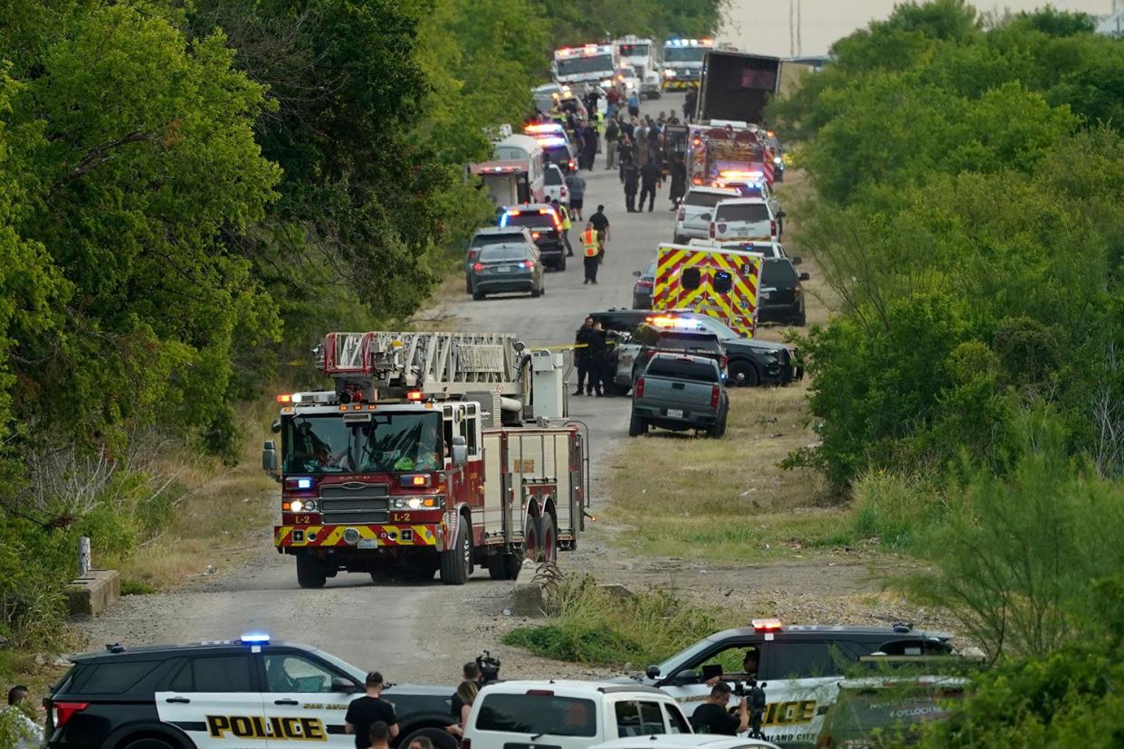 Mandatory Credit: Photo by Eric Gay/AP/Shutterstock (13008136a) Body bags lie at the scene where a tractor trailer with multiple dead bodies was discovered, in San Antonio Migrant Deaths, San Antonio, United States - 27 Jun 2022