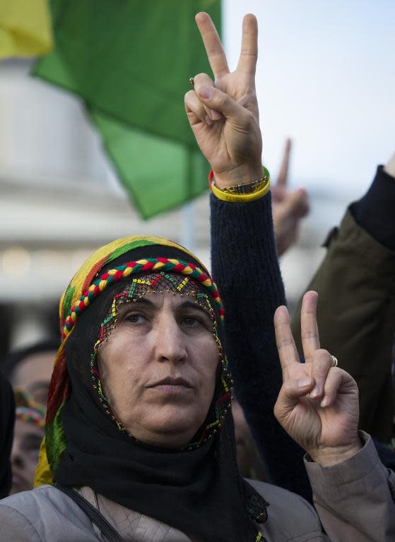 Protesters flash the "V" sign during a demonstration in London's Trafalgar Square on November 1, 2014, in a show of solidarity with Kurdish resistance to Islamic State, particularly in the mainly Kurdish Syrian town of Kobane