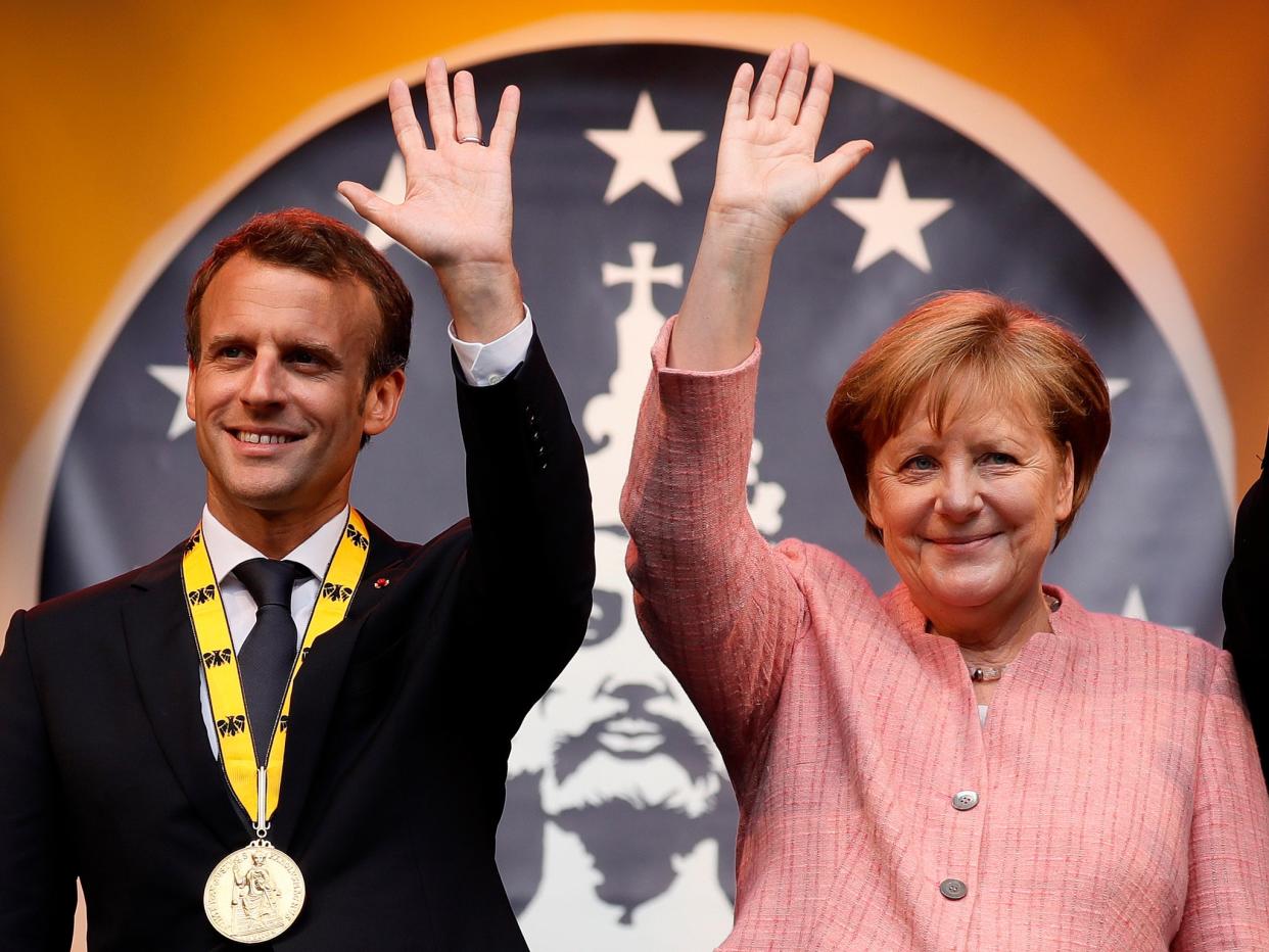 Angela Merkel presented the French president with the prize for his ‘European vision’: EPA