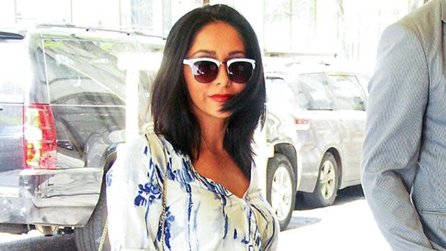 Daaang, girl! Former <em>Jersey Shore</em> star Nicole "Snooki" Polizzi was spotted in New York City on Thursday, looking almost unrecognizable from the girl we used to know on the beloved MTV reality program. Showing some leg in a flattering blue-and-white romper, the 27-year-old reality star accessorized with chic nude heels, a waist-accentuating bow belt, and a trendy fringe bag. Splash News PHOTOS: Snooki's Incredible Post- <em>Jersey Shore</em> Transformation Can we also point out how fabulous her dark bob looks on her? The mother-of two has made no secret about her commitment to working out and eating healthy, and often shows off the results on Instagram. "Almost 4 months post partum and so happy with my results," she wrote in January after giving birth to her daughter Giovanna in September. "I still have loose skin and stretch marks on my belly, but it's all worth it for my beautiful babies. Staying fit during pregnancy was the best thing I could ever do. Now it's time to build that muscle for summer 15! Big thanks to my trainer for kicking my body back into shape." VIDEO: 13 Things We've Learned From New Jersey Reality Shows ET caught up with the endearing star in January, when she revealed an embarrassing moment during her wedding to husband Jionni LaValle last November. Watch below!