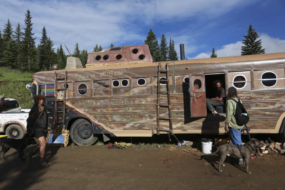 A modified school bus connected to the coffee-producing camp Montana Mud is seen on Friday, July 2, 2021, in the Carson National Forest, outside of Taos, N.M. More than 2,000 people have made the trek into the mountains of northern New Mexico as part of an annual counterculture gathering of the so-called Rainbow Family. While past congregations on national forest lands elsewhere have drawn as many as 20,000 people, this year’s festival appears to be more reserved. Members (AP Photo/Cedar Attanasio)