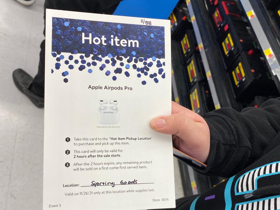 A customer holding a &quot;Hot Item&quot; document at a Walmart in LA