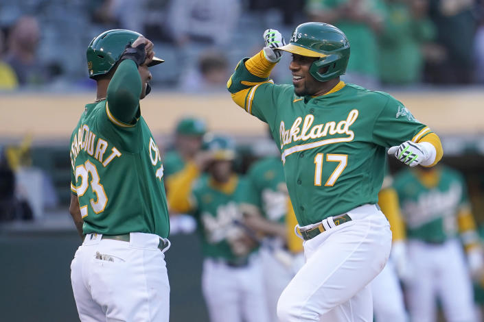 Oakland Athletics' Elvis Andrus (17) celebrates after hitting a two-run home run that scored Christian Bethancourt (23) during the second inning of a baseball game against the Houston Astros in Oakland, Calif., Friday, July 8, 2022. (AP Photo/Jeff Chiu)