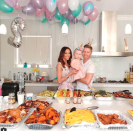 <p>The family posed in front of the feast that they had for their guests.</p>