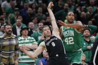 Brooklyn Nets' Goran Dragic (9) watches his 3-pointer next to Boston Celtics' Al Horford (42) during the first half of Game 2 of an NBA basketball first-round Eastern Conference playoff series, Wednesday, April 20, 2022, in Boston. (AP Photo/Michael Dwyer)