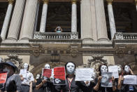 French tourist guides stage a protest regarding the impact on their sector due to the coronavirus outbreak, outside the Opera Garnier in Paris, France, Thursday, July 30, 2020. Tourism operators across Asia and Europe are making furtive and faltering advances, as well as some spectacular missteps, after travel was largely halted by the coronavirus pandemic that continues ebbing and mostly surging around the globe. (AP Photo/Rafael Yaghobzadeh)