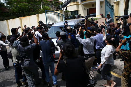 Members of the media surround a North Korea official's car as it leaves the North Korea embassy in Kuala Lumpur, Malaysia. REUTERS/Athit Perawongmetha