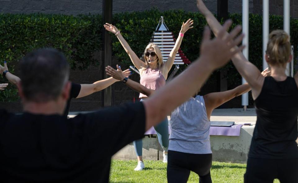 Studio V instructor Victoria Popoff leads a free Pilates class at the Modesto Rotary Music Garden outside the Gallo Center for the Arts in Modesto, Calif., Saturday, August 5, 2023.