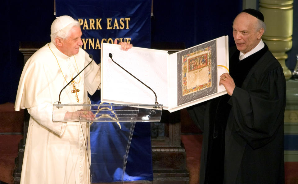 FILE - Pope Benedict XVI presents a Jewish codex book to Rabbi Arthur Schneier, right, during his visit to the Park East Synagogue in New York on April 18, 2008. Benedict made outreach to Jews a hallmark of his papacy and, in one of his most significant acts, he made a sweeping exoneration of the Jewish people for the death of Christ. Benedict, the German theologian who will be remembered as the first pope in 600 years to resign, has died, the Vatican announced Saturday Dec. 31, 2022. He was 95. (AP Photo/Stephen Chernin, File)