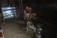 Bangladeshi man tries to remove muddy water from his flooded home in Sylhet, Bangladesh, Wednesday, June 22, 2022. (AP Photo/Mahmud Hossain Opu)